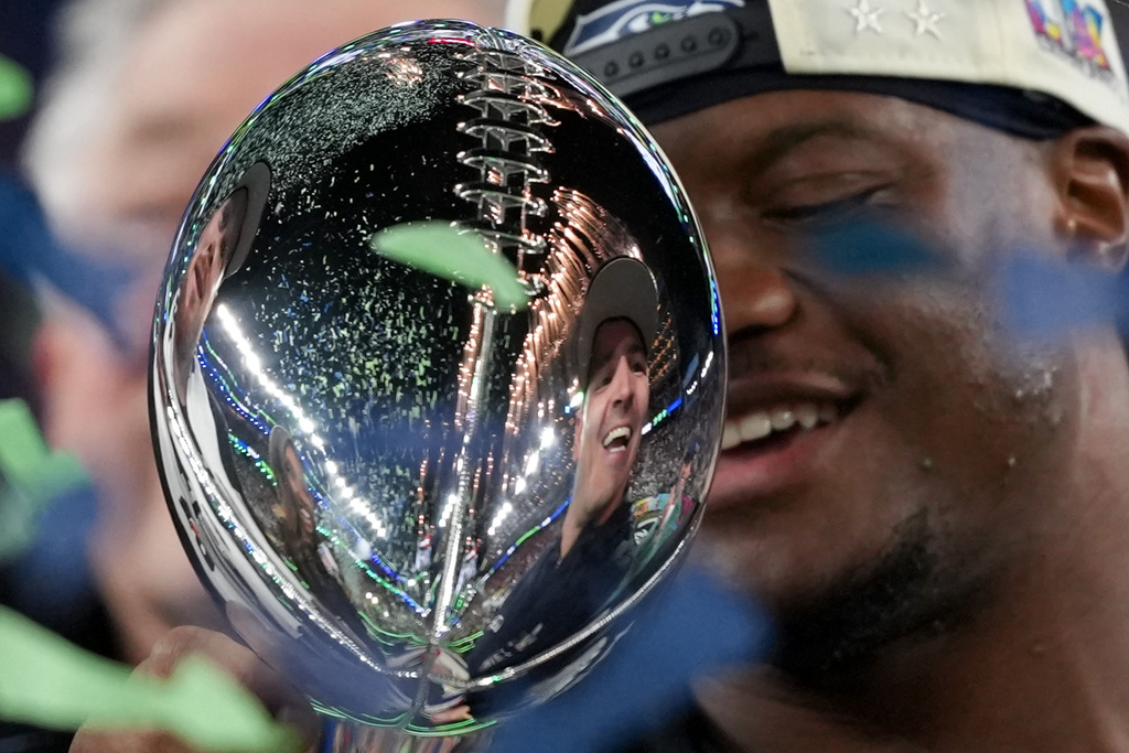 Seattle Seahawks head coach Mike Macdonald is reflected in the Lombardi Trophy after a win over the New England Patriots in the NFL Super Bowl 60 football game Sunday, Feb. 8, 2026, in Santa Clara, Calif. (AP Photo/Matt Slocum)