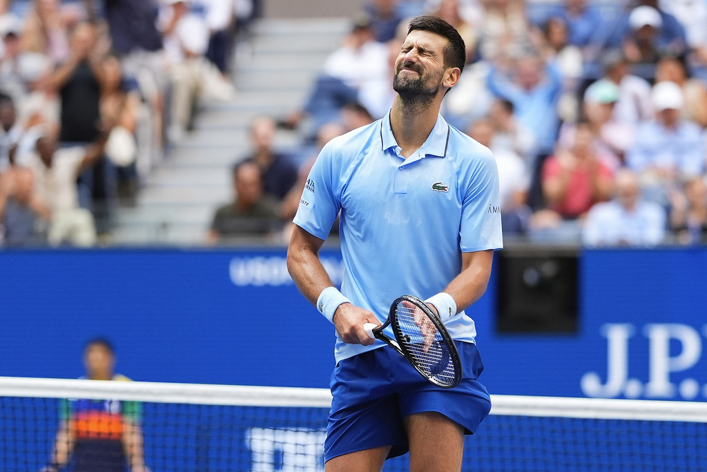 Novak Djokovic, of Serbia, reacts after a rally against Carlos Alcaraz, of Spain, during the men's singles semifinals of the U.S. Open tennis championships, Friday, Sept. 5, 2025, in New York. (AP Photo/Yuki Iwamura)