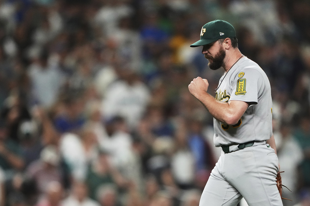 Athletics pitcher Hogan Harris reacts to earning the save in the 10th inning against the Seattle Mariners in a baseball game Saturday, Aug. 23, 2025, in Seattle. (AP Photo/Lindsey Wasson)