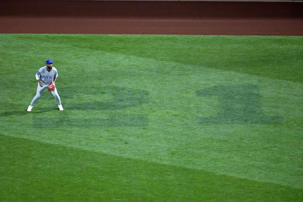 Chicago Cubs right fielder Willi Castro gets set for a pitch in right field of PNC Park, where in honor of Roberto Clemente Day a No. 21 is painted on the grass, during a baseball game against the Pittsburgh Pirates in Pittsburgh, Monday, Sept. 15, 2025. (AP Photo/Gene J. Puskar)