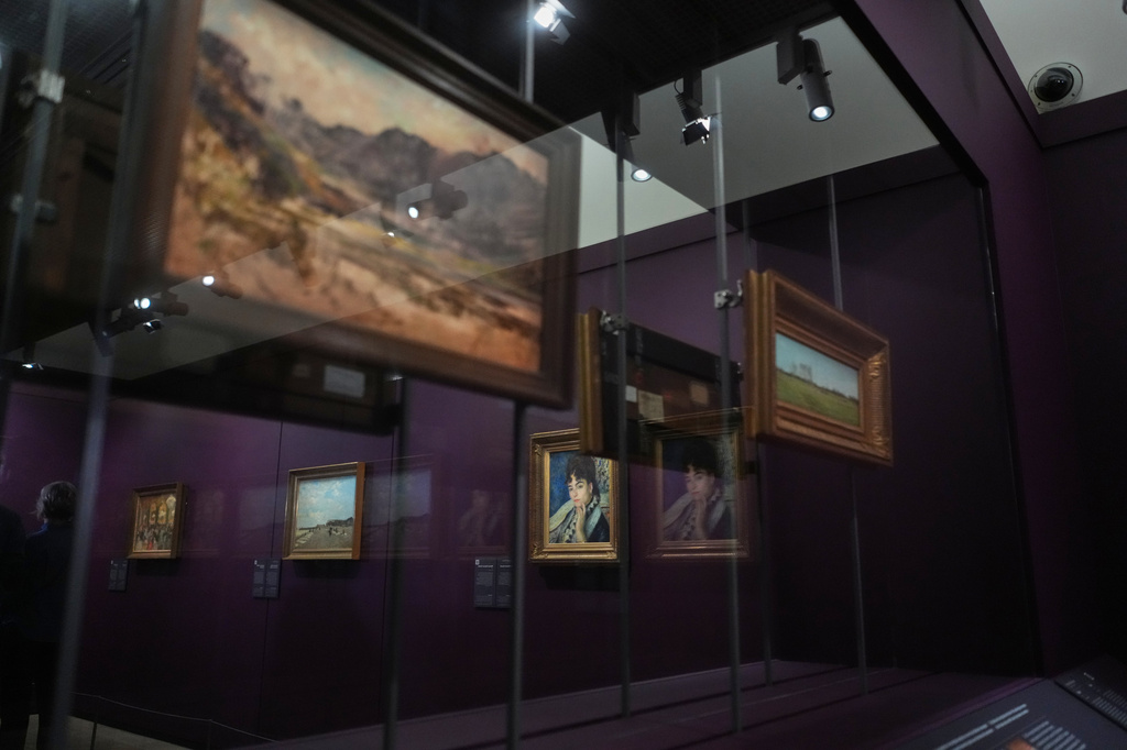French painter Pierre-Auguste Renoir's painting titled Madame Alphonse Daudet, center, is on exhibit in the Musée d'Orsay museum's new permanent gallery dedicated to so-called MNR artworks, pieces recovered after World War II whose ownership remains uncertain, in Paris, Monday, May 4, 2026. (AP Photo/Thibault Camus)