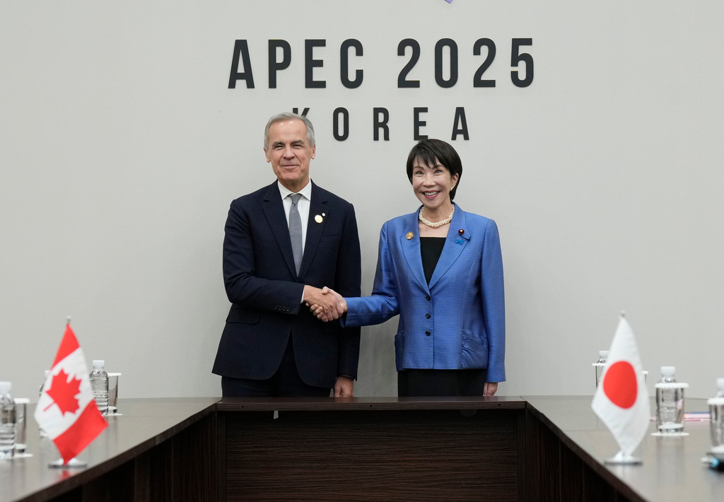 Canada's Prime Minister Mark Carney, left, meets with Japanese Prime Minister Sanae Takaichi at the APEC summit in Gyeongju, South Korea, Saturday, Nov. 1, 2025. (Adrian Wyld/The Canadian Press via AP)