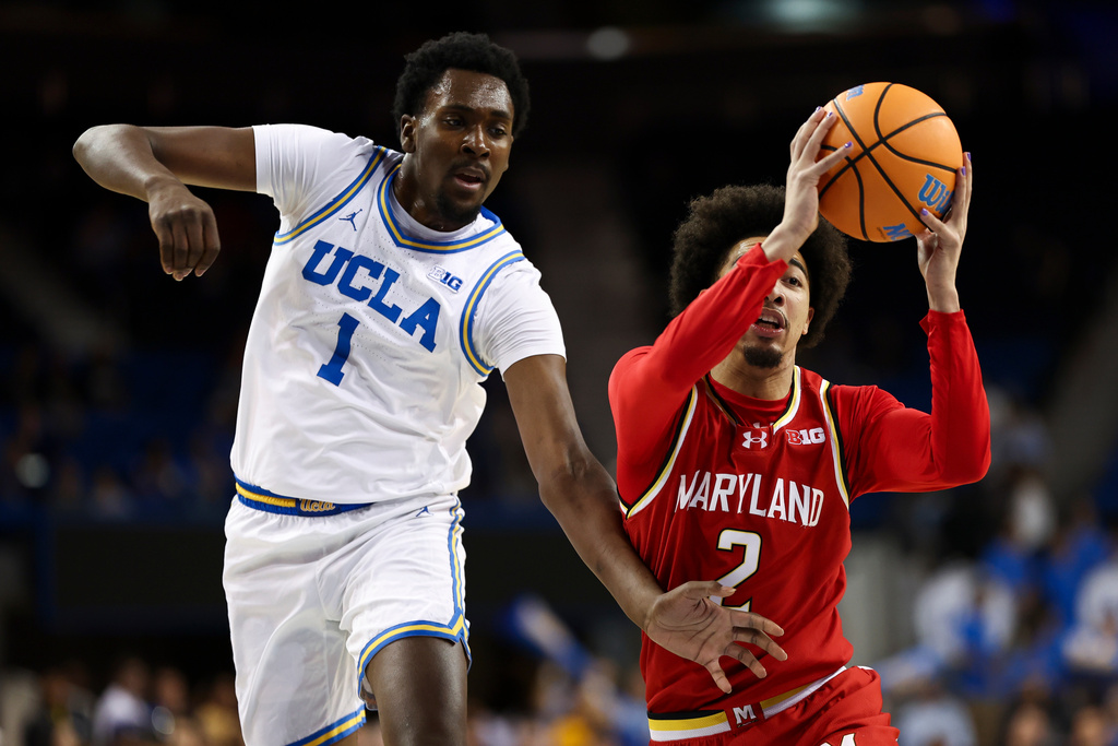 Maryland guard Myles Rice (2) drives against UCLA center Xavier Booker (1) during the first half of an NCAA college basketball game, Saturday, Jan. 10, 2026, in Los Angeles. (AP Photo/Jessie Alcheh)