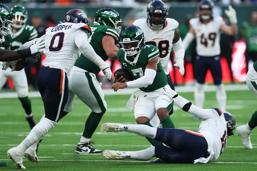 New York Jets quarterback Justin Fields, center, is sacked by Denver Broncos linebackers Jonathon Cooper, left, and Alex Singleton in the second half of an NFL football game Sunday, Oct. 12, 2025, in London. (AP Photo/Ian Walton) New York Jets quarterback Justin Fields, center, is sacked by Denver Broncos linebackers Jonathon Cooper, left, and Alex Singleton in the second half of an NFL football game Sunday, Oct. 12, 2025, in London. (AP Photo/Ian Walton)