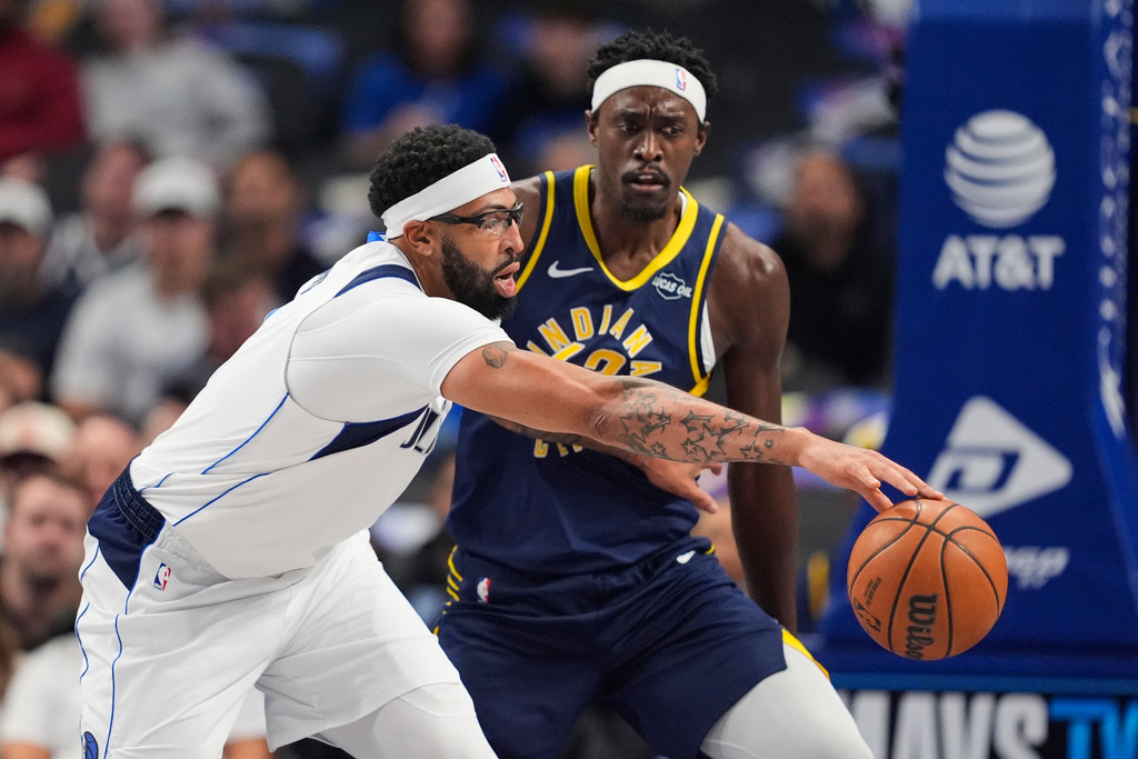Dallas Mavericks forward Anthony Davis, left, moves to gain control of the ball in front of Indiana Pacers' Pascal Siakam, right, in the first half of an NBA basketball game Wednesday, Oct. 29, 2025, in Dallas. (AP Photo/Tony Gutierrez)