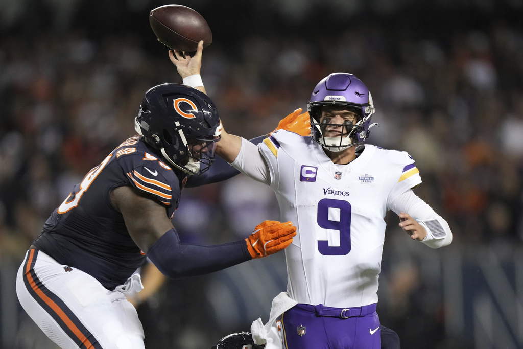 Minnesota Vikings quarterback J.J. McCarthy (9) throws under pressure from Chicago Bears defensive lineman Gervon Dexter Sr. during the second half of an NFL football game Monday, Sept. 8, 2025, in Chicago. (AP Photo/Nam Y. Huh)