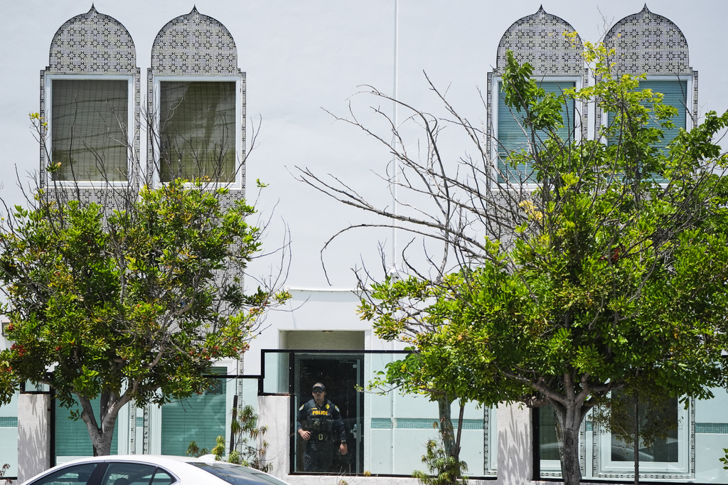 Police stage at the scene of a shooting outside the Islamic Center of San Diego Monday, May 18, 2026, in San Diego. (AP Photo/Gregory Bull)