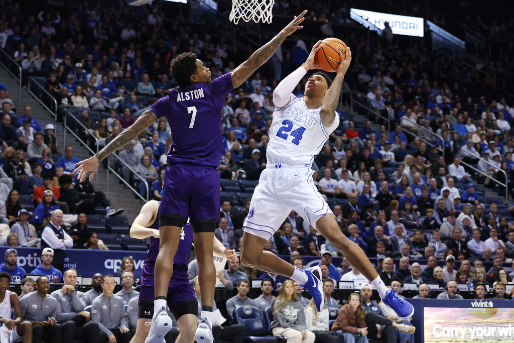 BYU forward Dominique Diomande (24) drives on Abilene Christian guard Christian Alston during the second half of an NCAA college basketball game Friday, Dec. 19, 2025, in Provo, Utah. (AP Photo/Jeffrey D. Allred)