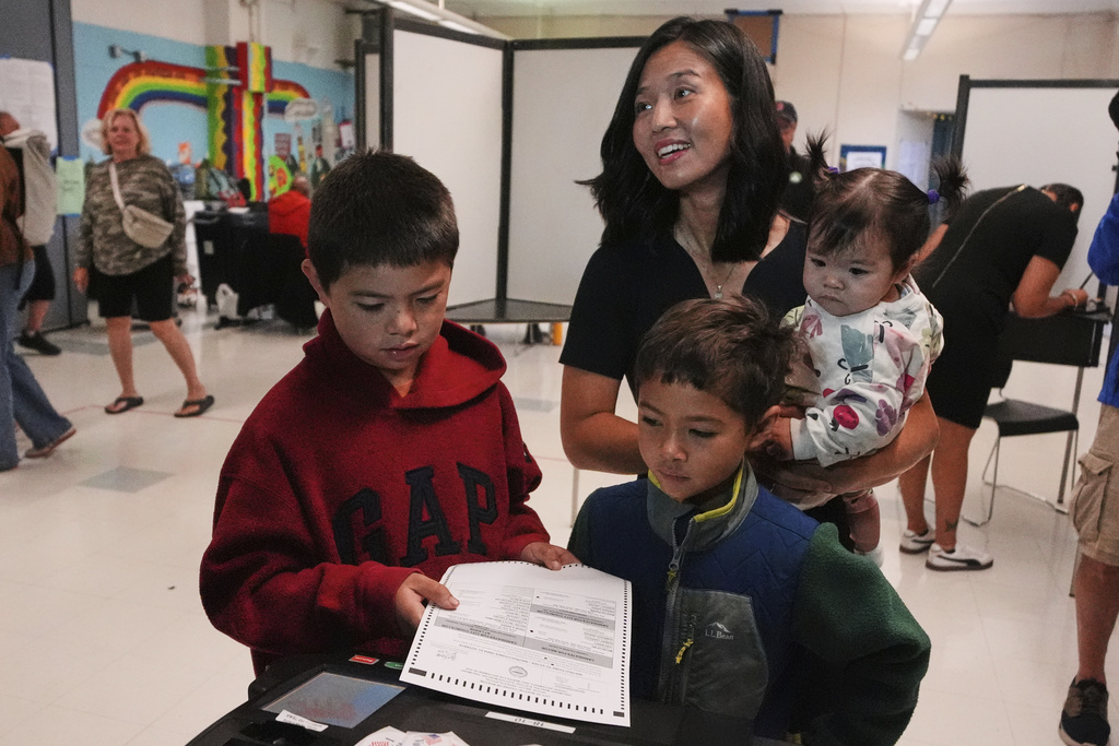 Boston Mayor Michelle Wu votes with her children Blaise, Cass and Mira, from left, at a polling place, Tuesday, Sept. 9, 2025, in the Roslindale neighborhood of Boston. (AP Photo/Charles Krupa)