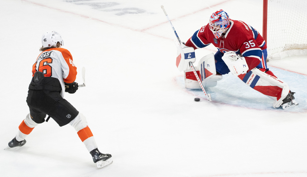 Philadelphia Flyers' Trevor Zegras (46) scores on Montreal Canadiens goaltender Sam Montembeault (35) during shootout NHL hockey action in Montreal on Tuesday, Nov. 4, 2025. (Christinne Muschi/The Canadian Press via AP)