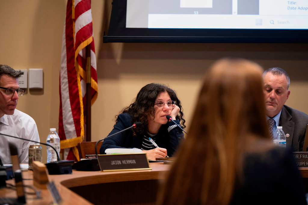 Members of the Lower Merion Board of School Directors speak with attendees at a school board meeting on Monday, May 11, 2026, in Ardmore, Pa. (AP Photo/Joe Lamberti)