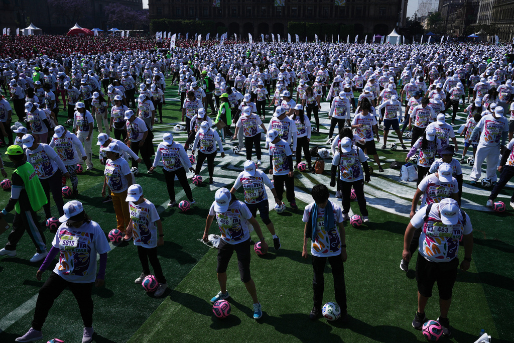 People practice soccer skills in an attempt to set a Guinness World Record for the "largest soccer class" at the Zocalo in Mexico City, Sunday, March 15, 2026. (AP Photo/Marco Ugarte)