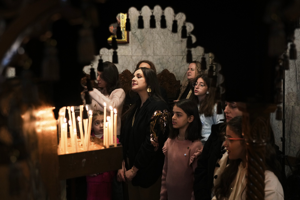 Palestinian Orthodox worshippers attend Christmas Mass at the Orthodox Church of St. Porphyrius in Gaza City Wednesday, Jan. 7, 2026. (AP Photo/Jehad Alshrafi)