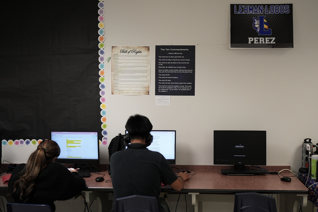 FILE - Students work under Ten Commandments and Bill of Rights posters on display in a classroom at Lehman High School, in Kyle, Texas, Oct. 16, 2025. (AP Photo/Eric Gay, File)