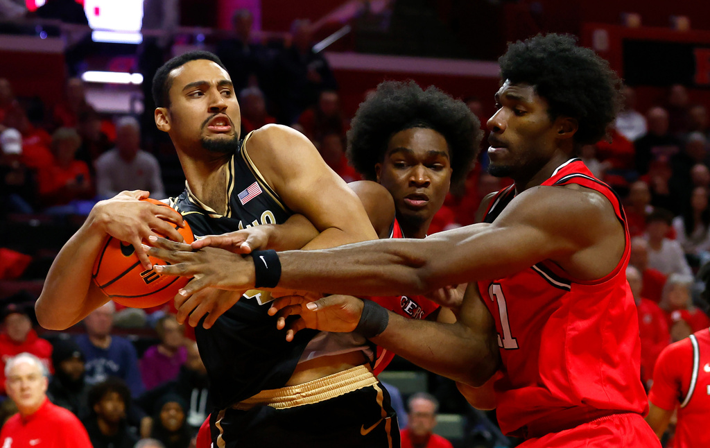 Purdue forward Trey Kaufman-Renn, left, battles Rutgers guards Jamichael Davis (1) and Kaden Powers for the ball during the first half of an NCAA college basketball game, Tuesday, Dec. 2, 2025, in Piscataway, N.J. (AP Photo/Noah K. Murray)