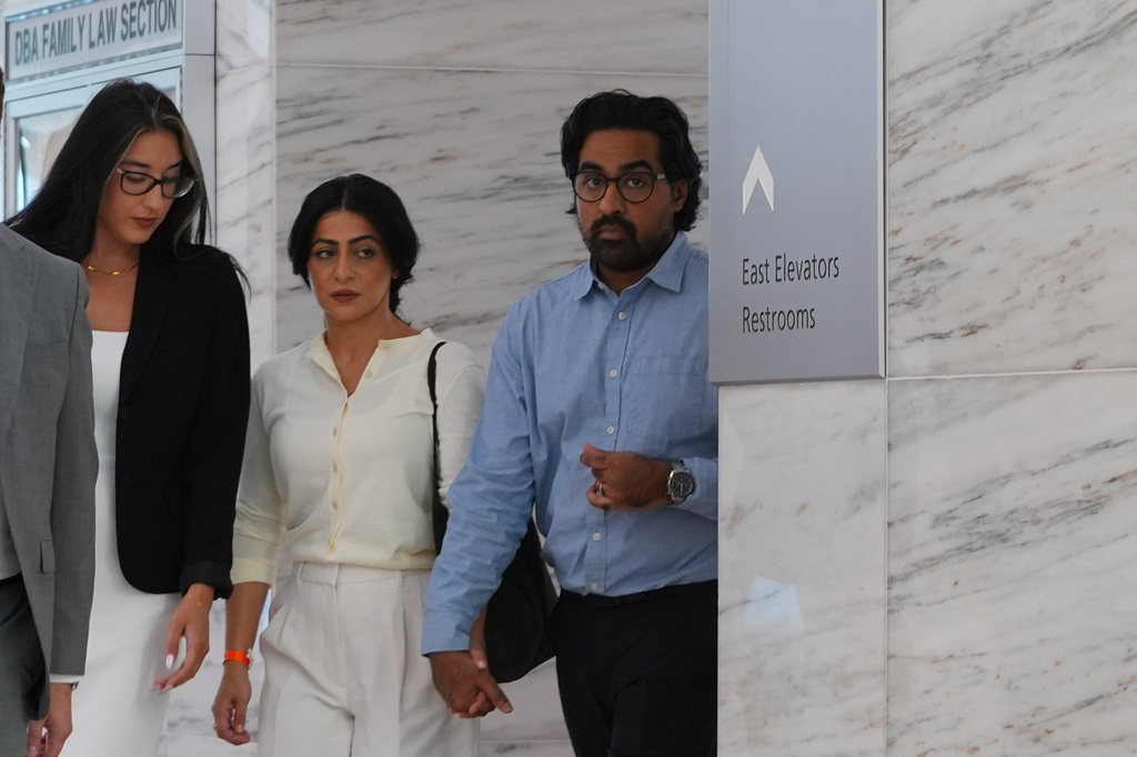Omar Ahmed, right, and his wife Nausheen Gilkar, center, arrive for a court hearing in Dallas, Tuesday, Aug. 25, 2026. (AP Photo/LM Otero)