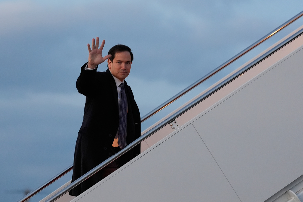 Secretary of State Marco Rubio waves as he boards his plane, Thursday, Feb. 12, 2026, at Joint Base Andrews, Md., en route to the Munich Security Conference. (AP Photo/Alex Brandon, Pool)