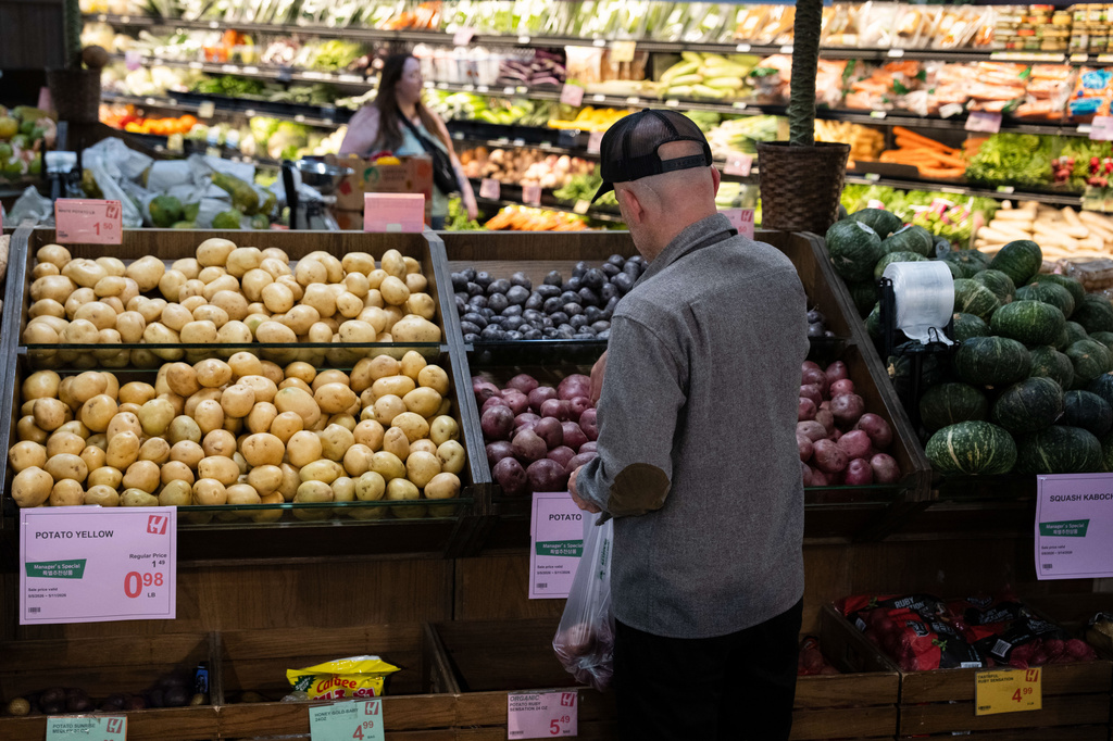 Customers shop in the produce section of a grocery store on Monday, May 11, 2026, in Portland, Ore. (AP Photo/Jenny Kane)