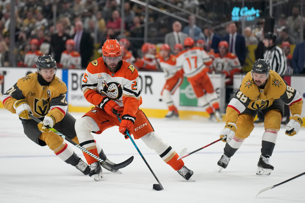 Anaheim Ducks center Ryan Poehling (25) skates against Vegas Golden Knights center William Karlsson (71) and Vegas Golden Knights center Tomas Hertl (48) during the first period of Game 2 of a second-round NHL hockey Stanley Cup playoff series Wednesday, May 6, 2026, in Las Vegas. (AP Photo/John Locher)
