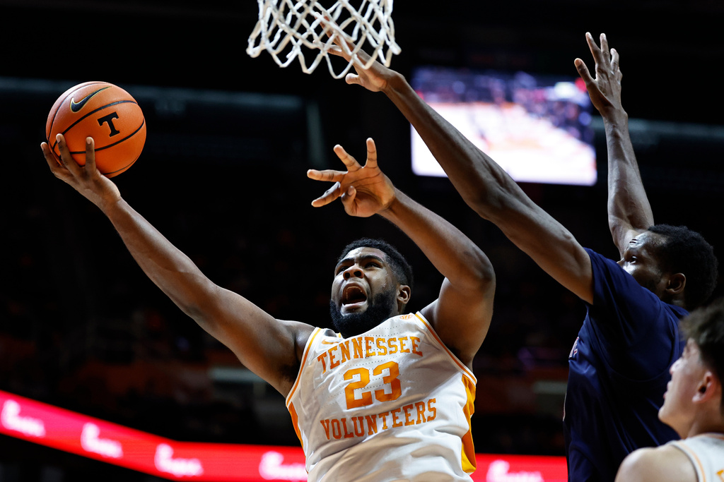 Tennessee forward Jaylen Carey (23) shoots past South Carolina State forward James Morrow (22) during the first half of an NCAA college basketball game Tuesday, Dec. 30, 2025, in Knoxville, Tenn. (AP Photo/Wade Payne)