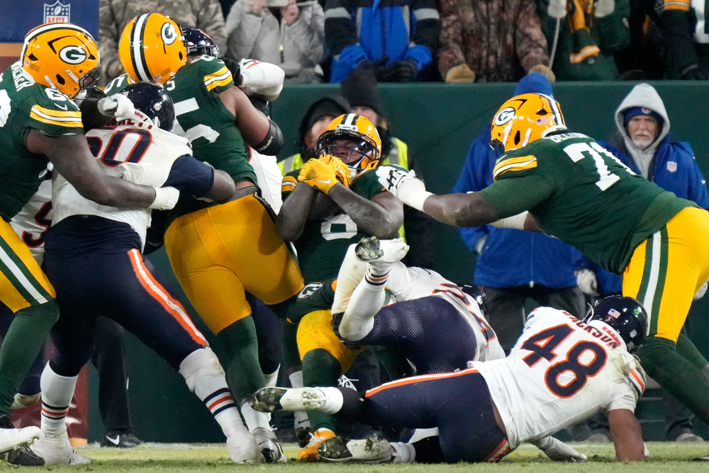 Green Bay Packers running back Josh Jacobs (8) scores a touchdown against the Chicago Bears during the second half of an NFL football game Sunday, Dec. 7, 2025, in Green Bay, Wis. (AP Photo/Morry Gash)