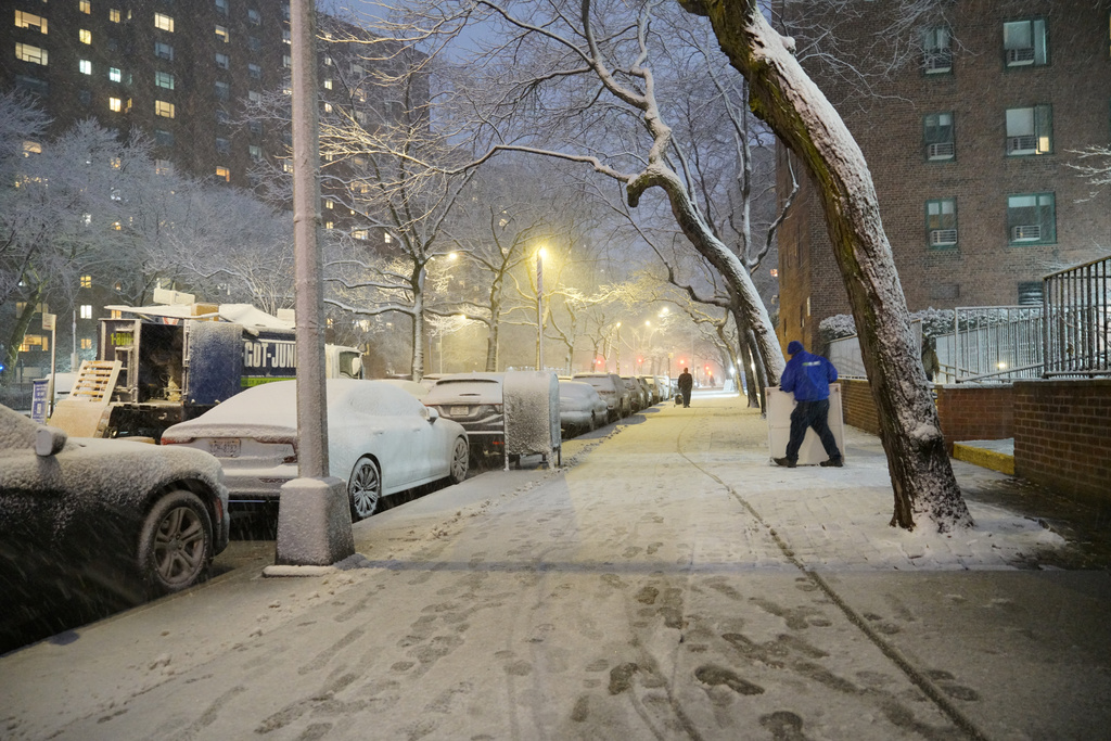 A man works in a snowstorm, Sunday, Feb. 22, 2026, in New York. (AP Photo/Pamela Hassell)