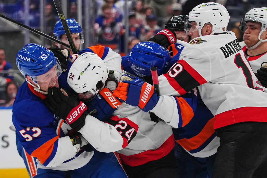 New York Islanders' Casey Cizikas (53) fights with Ottawa Senators' Dylan Cozens (24) during the third period of an NHL hockey game Saturday, April 11, 2026, in Elmont, N.Y. (AP Photo/Frank Franklin II)