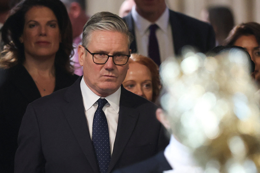 British Prime Minister Keir Starmer, center, walks through the House of Commons to attend the State Opening of Parliament at the Palace of Westminster, London, Wednesday, May 13, 2026. (Toby Melville/Pool Photo via AP)