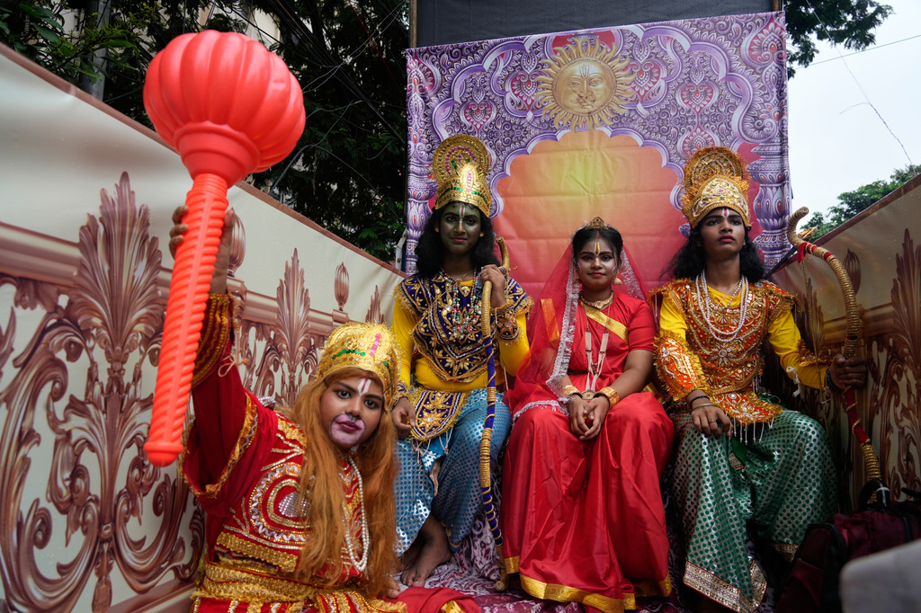 Children dressed as Hindu deities Rama and wife Sita, Lakshman and monkey god Hanuman travel on a chariot as they participate in a religious procession during the Rath Yatra, or chariot festival, carrying the Hindu deities of Jagannath, Balaram and Subhadra, in Kolkata, India, Thursday, July 16, 2026. (AP Photo/Bikas Das)