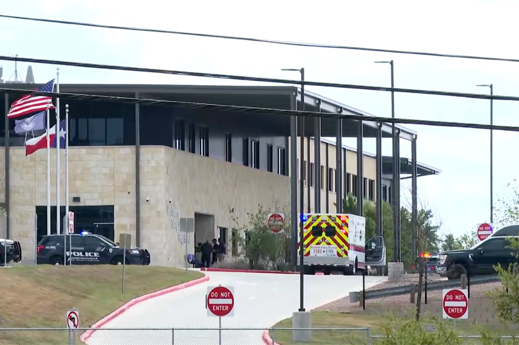 This image taken from video provided by KSAT shows first responders outside after a student shot a teacher at Hill Country College Preparatory High School, Monday, March 30, 2026, in Bulverde, Texas. (KSAT via AP)