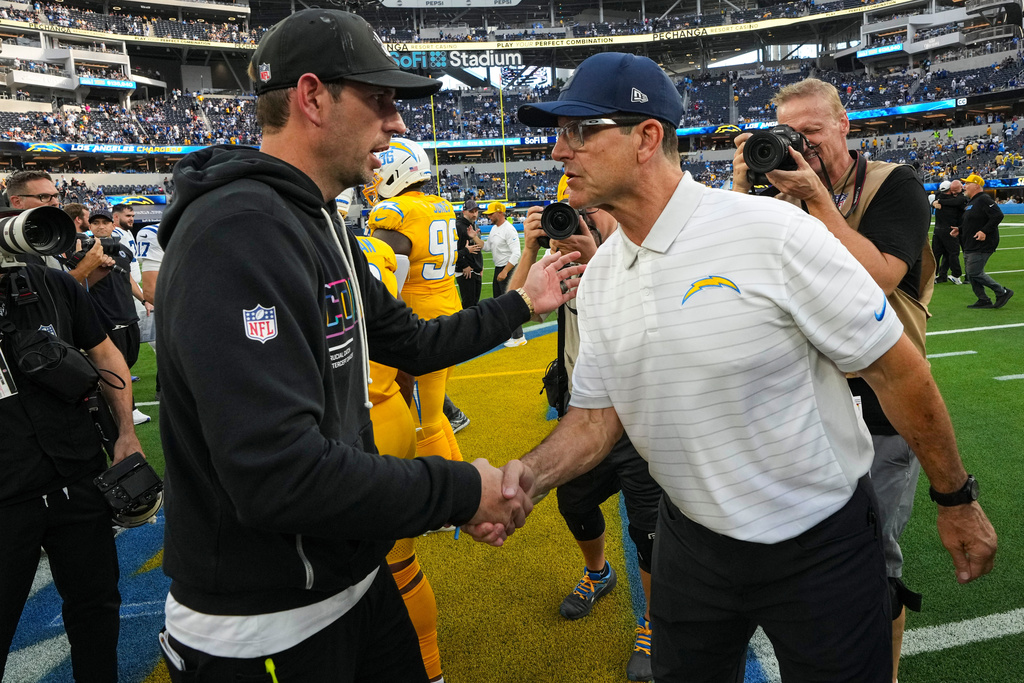 Indianapolis Colts head coach Shane Steichen, left, greets Los Angeles Chargers head coach Jim Harbaugh following an NFL football game Sunday, Oct. 19, 2025, in Inglewood, Calif. (AP Photo/Gregory Bull)
