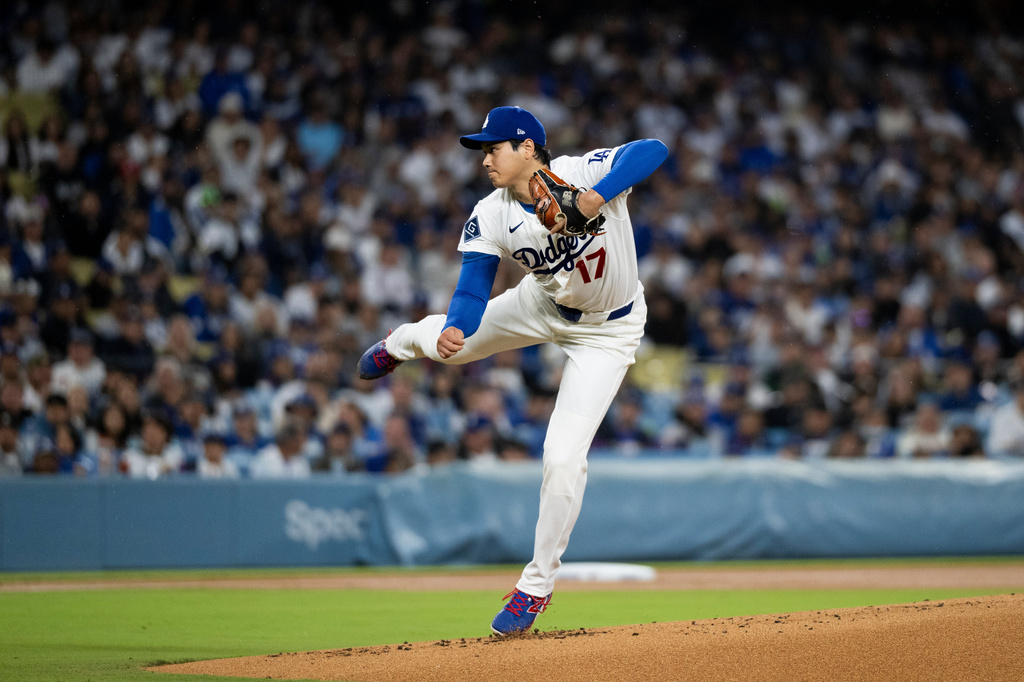 Los Angeles Dodgers starting pitcher Shohei Ohtani delivers during the first inning of a baseball game against the Cleveland Guardians in Los Angeles, Tuesday, March 31, 2026. (AP Photo/Kyusung Gong)