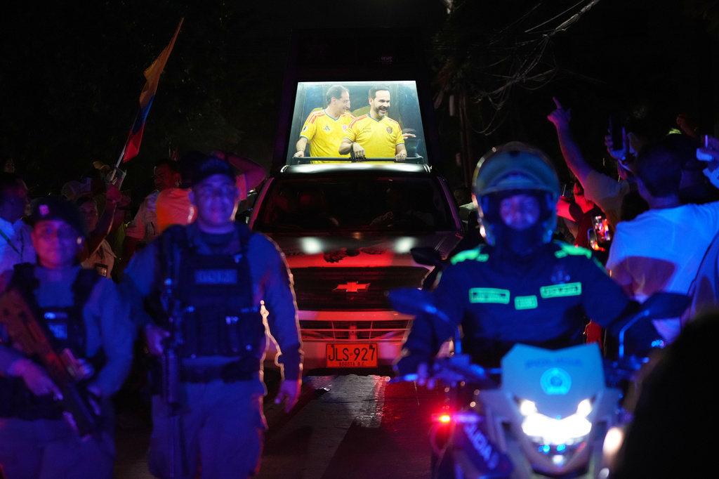 FILE - Presidential candidate Abelardo de la Espriella of the opposition Defenders of the Motherland movement and his vice-presidential running mate, Jose Manuel Restrepo, ride in a bulletproof booth toward a celebration rally after election results showed him leading, in Barranquilla, Colombia, June 21, 2026. (AP Photo/Rodrigo Abd, File)
