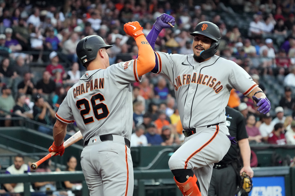 San Francisco Giants' Willy Adames, right, celebrates with Matt Chapman (26) after hitting a solo home run against the Arizona Diamondbacks in the second inning of a baseball game, Tuesday, May 19, 2026, in Phoenix. (AP Photo/Rick Scuteri) CORRECTION: Corrects to May 19 not May 20.