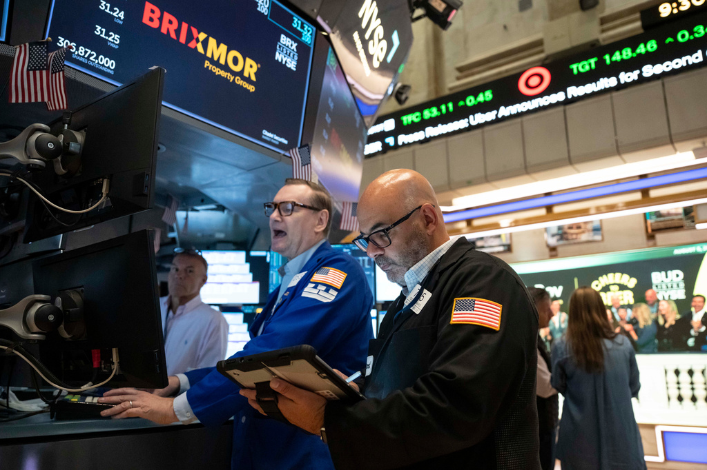 Trader Fred Demarco, right, and Specialist Patrick King, left, work on the floor of the New York Stock Exchange, Wednesday, Aug.. 5, 2026, in New York. (AP Photo/Yuki Iwamura)