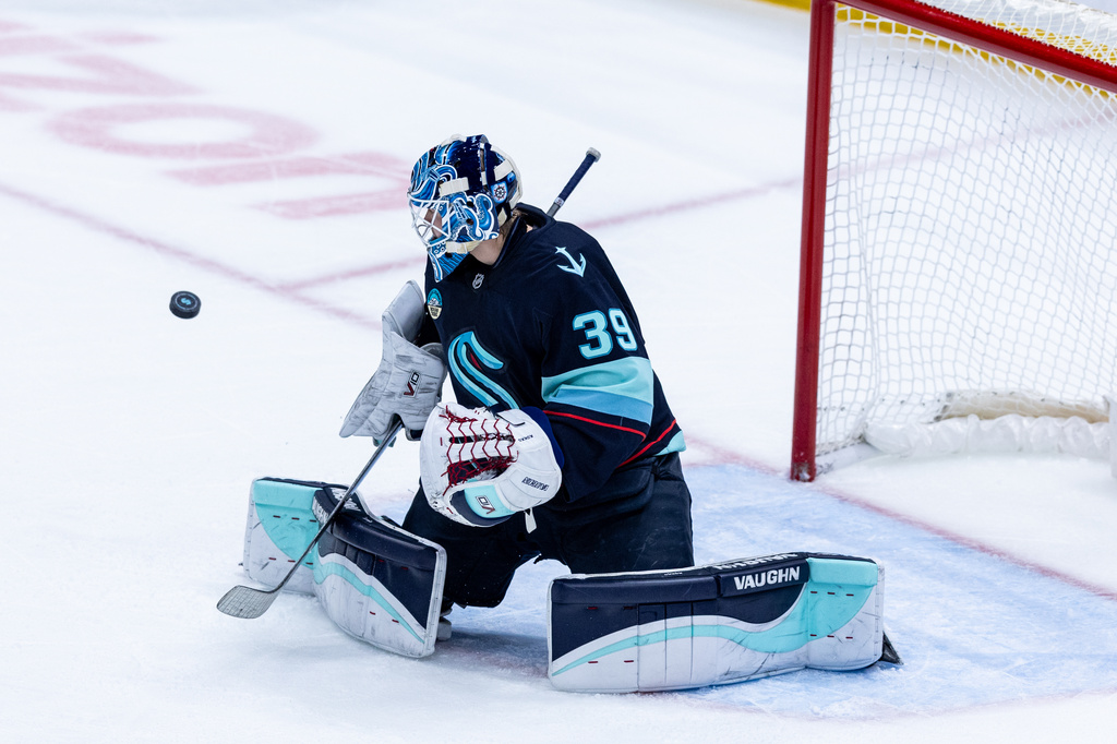 Seattle Kraken goaltender Nikke Kokko makes a save during the first period of an NHL hockey game against the Calgary Flames, Saturday, April 11, 2026, in Seattle. (AP Photo/Maddy Grassy)
