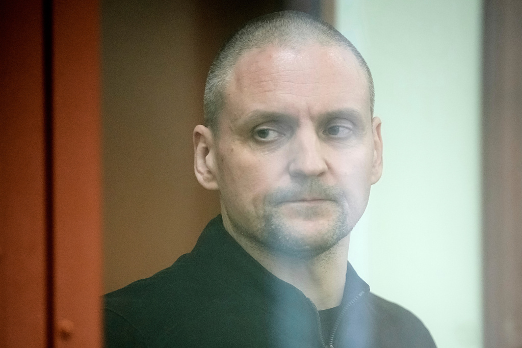 FILE - Sergei Udaltsov, a political activist, stands behind glass in a cage in a courtroom prior to a session in Moscow, Russia, Monday, April 21, 2025. (AP Photo/Pavel Bednyakov, File)
