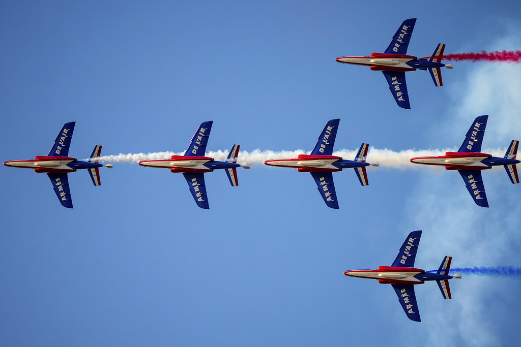 Pilots of the Patrouille de France (PAF), the precision aerobatics unit of the French Air and Space Force, perform above the runway of the Aurel Vlaicu airport, on the first day of the Bucharest International Air Show, BIAS 2025 in Bucharest, Romania, Saturday, Aug. 30, 2025. (AP Photo/Andreea Alexandru)