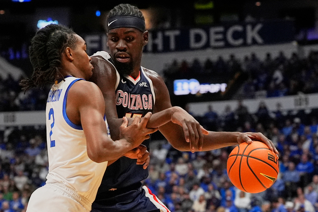 Gonzaga forward Graham Ike (15) dribbles the ball past Kentucky guard Jasper Johnson (2) during the first half of an NCAA college basketball game Friday, Dec. 5, 2025, in Nashville, Tenn. (AP Photo/George Walker IV)