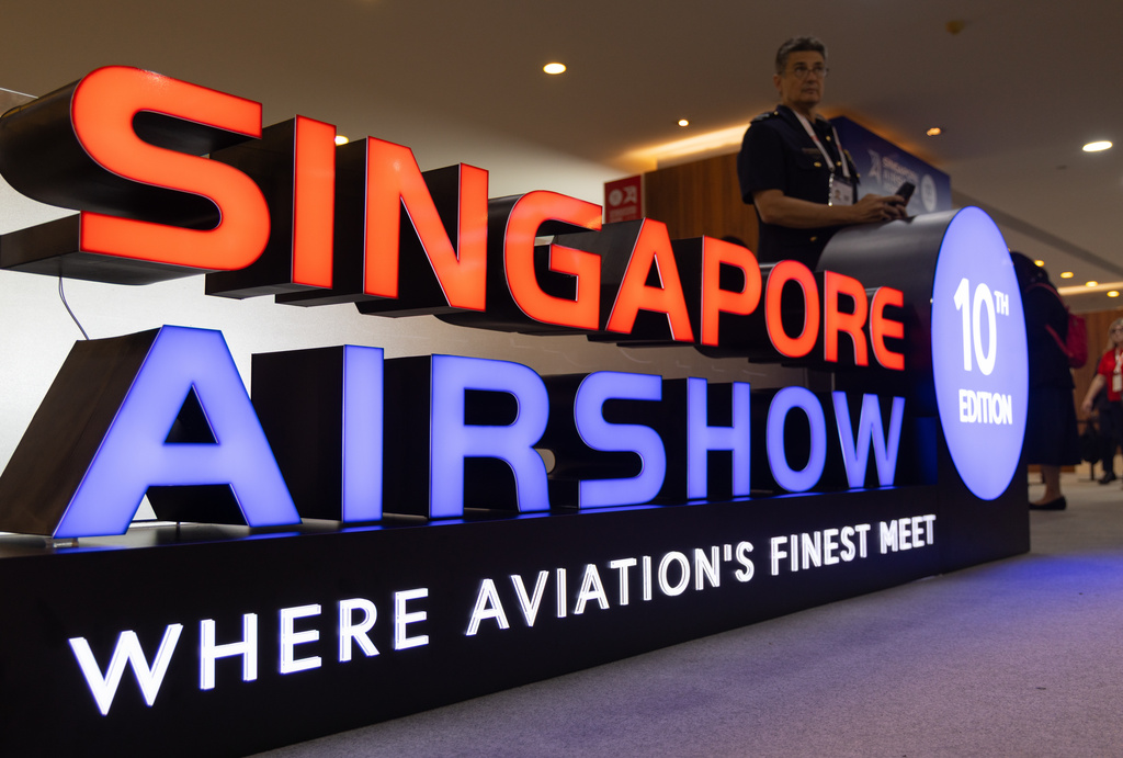 A member of the Australian Defence Force leans on a sign for the Singapore Airshow on Tuesday, Feb. 3, 2026. (AP Photo/Anton L. Delgado)