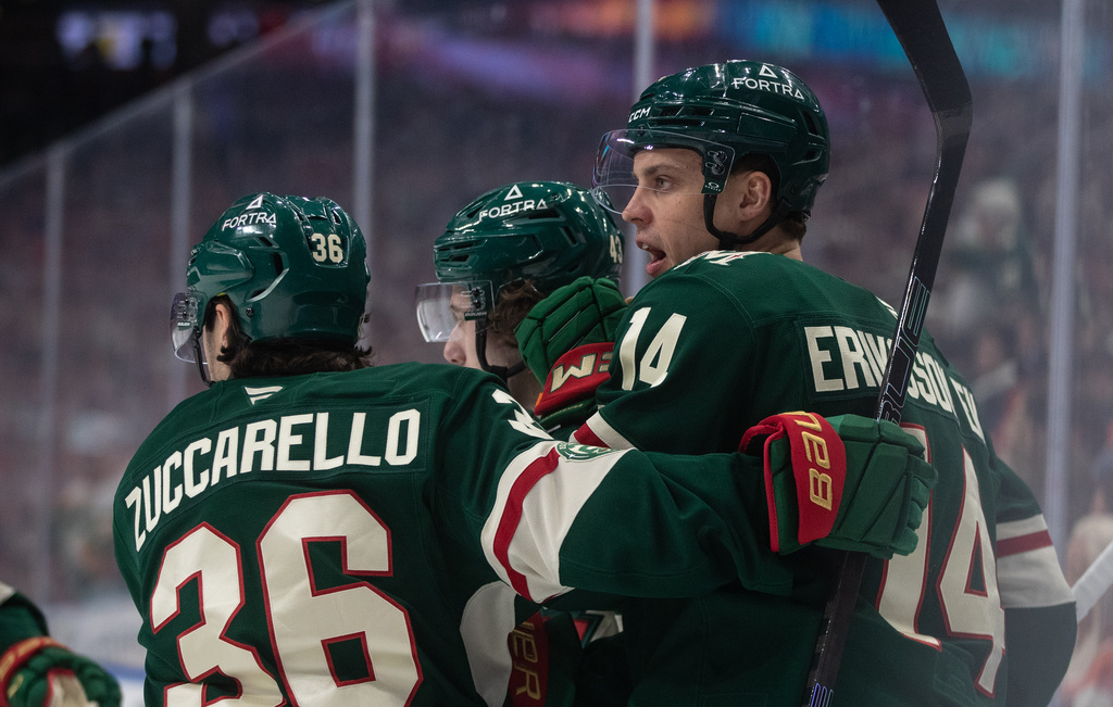 Minnesota Wild's Mats Zuccarello (36), Joel Eriksson Ek (14) and Quinn Hughes (43) celebrate after a goal against the Edmonton Oilers during first-period NHL hockey game action in Edmonton, Alberta, Saturday, Jan. 31, 2026. (Jason Franson/The Canadian Press via AP)