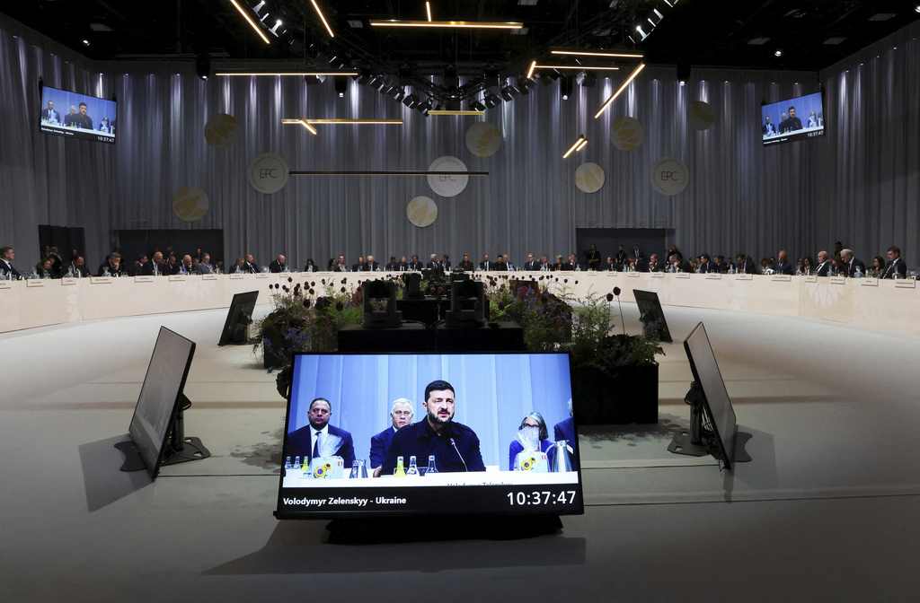 Ukrainian President Volodymyr Zelenskyy is seen on a giant screen as he speaks during the European Political Community summit, in Copenhagen, Thursday, Oct. 2, 2025. (Suzanne Plunkett/Pool Photo via AP)