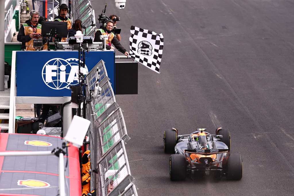 The checkered flag is waved as McLaren driver Lando Norris of Britain crosses the finish line to win the Brazilian Formula One Grand Prix at the Interlagos race track in Sao Paulo, Sunday, Nov. 9, 2025. (Jean Carniel /Pool Photo via AP)