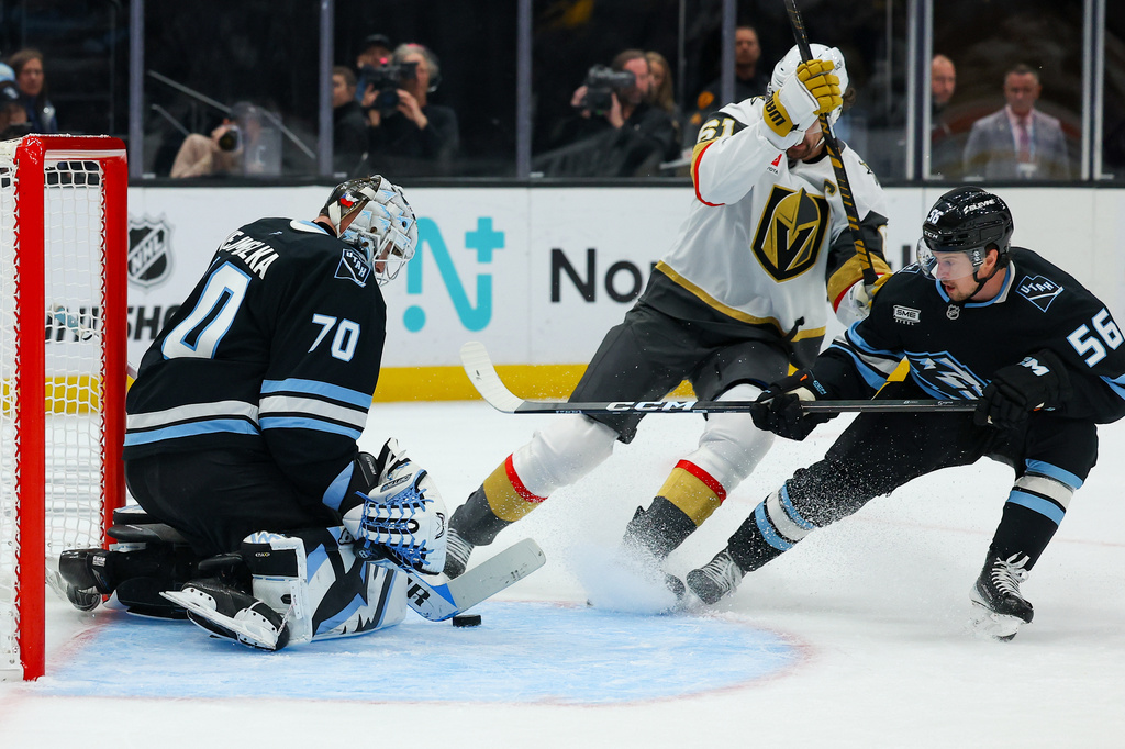 Utah Mammoth goaltender Karel Vejmelka (70) and right wing Kailer Yamamoto (56) blocks the puck against Vegas Golden Knights right wing Mark Stone (61) during the second period of Game 6 in the first round of an NHL hockey Stanley Cup playoff series, Friday, May 1, 2026, in Salt Lake City. (AP Photo/Melissa Majchrzak)