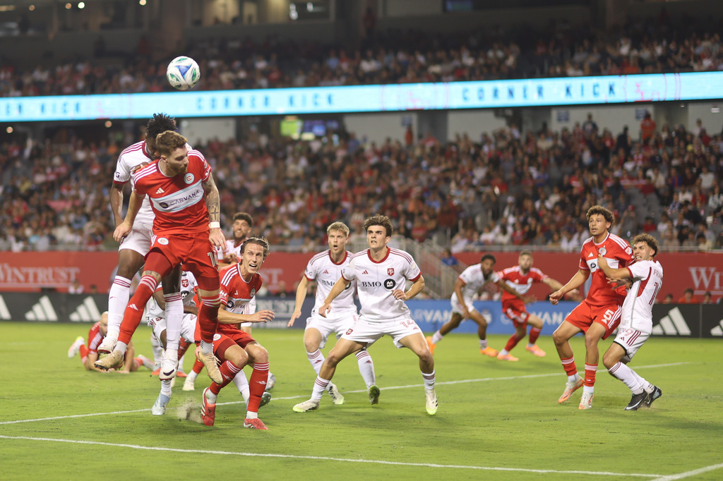 Chicago Fire center-back Joel Waterman, front left, and Toronto FC midfielder Matthew Longstaff, back left, battle for a header during the first half of an MLS soccer match Saturday, Oct. 4, 2025, in Chicago. (AP Photo/Talia Sprague)