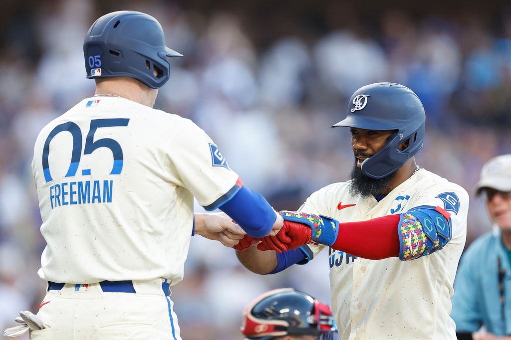 Los Angeles Dodgers' Teoscar Hernandez (37) is greeted by Los Angeles Dodgers' Freddie Freeman (5) after hitting a two-run home run during the second inning of a baseball game against the Boston Red Sox, Saturday, Aug. 1, 2026, in Los Angeles. (AP Photo/Caroline Brehman)