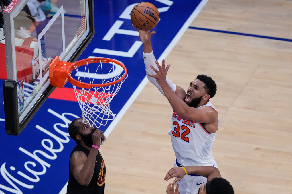New York Knicks center Karl-Anthony Towns (32) shoots over Cleveland Cavaliers guard James Harden, left, during the second half of Game 1 in the Eastern Conference finals NBA basketball playoffs series, Tuesday, May 19, 2026, in New York. (AP Photo/Yuki Iwamura)
