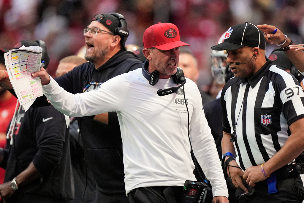 San Francisco 49ers head coach Kyle Shanahan, left, talks to line judge Brian Perry (97) during the second half of an NFL football game against the Atlanta Falcons in Atlanta, Sunday, Oct. 25, 2026. (AP Photo/Mike Stewart)