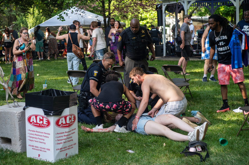 Police treat a person after multiple people were shot at a community festival Saturday, June 6, 2026, in Toledo, Ohio. (Rich Berry via AP)