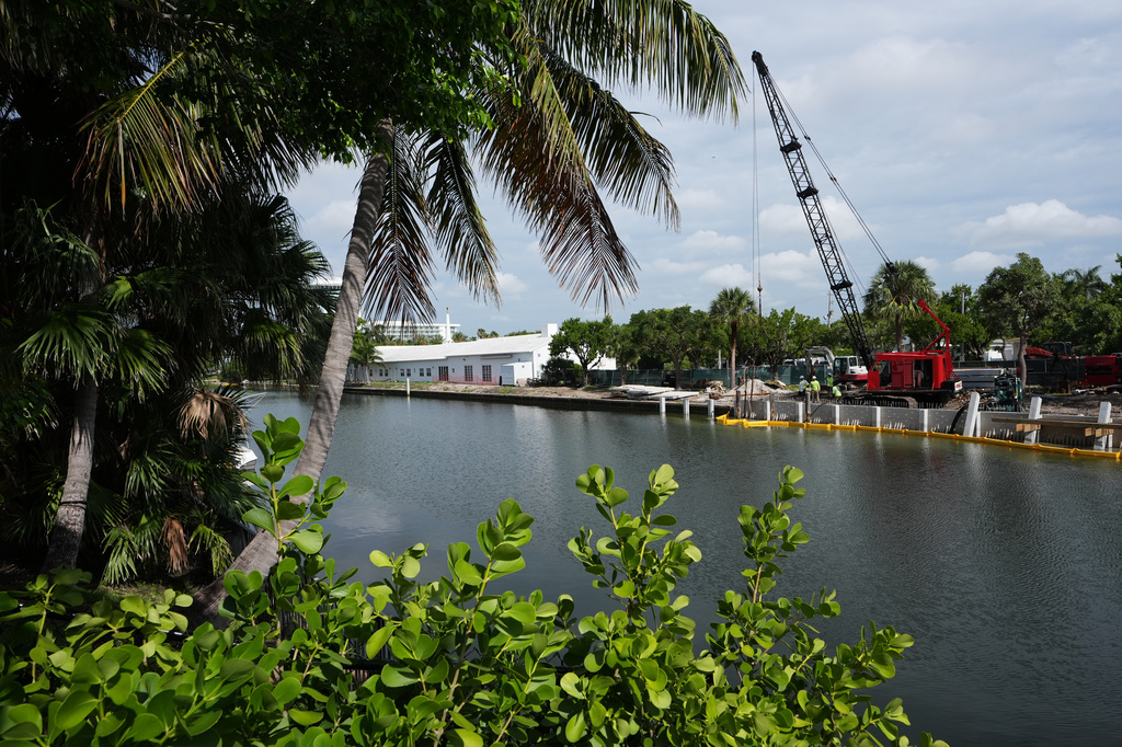 Workers install a 3D-printed living seawall manufactured by Kind Designs at the Church by the Sea, Tuesday, Aug. 4, 2026, in Fort Lauderdale, Fla. (AP Photo/Lynne Sladky)